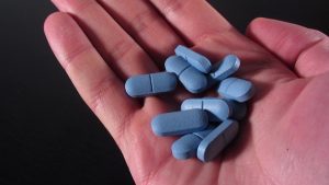 blue Viagra pills in hand for dr. hank